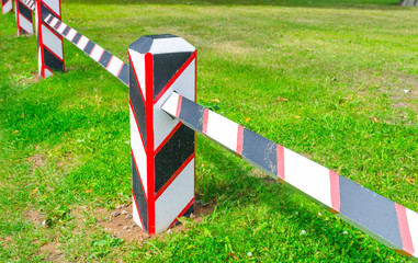 Fortress military wooden border fence barrier with post on green grass lawn in Peter and Paul Fortress citadel on Zayachy Hare Island, Saint Petersburg Leningrad city, Russia