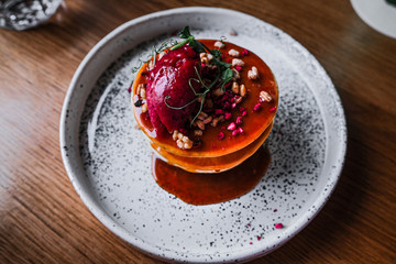 dessert with raspberries honey nuts on a beautiful plate