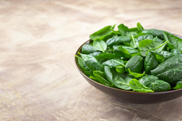 Fresh spinach leaves on culinary background