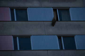 Pink and blue windows with a curtain hanging out