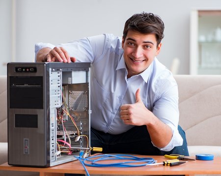 IT technician repairing broken pc desktop computer