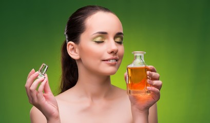 Young woman with bottle of perfume