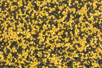 bakcground of sugar sprinkles in black and gold