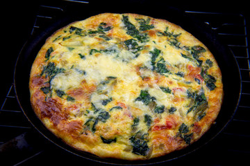 Frittata made of eggs, bacon, cheese and spinach
