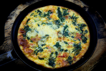 Frittata made of eggs, bacon, cheese and spinach
