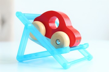 Woden car toy in deck chair.