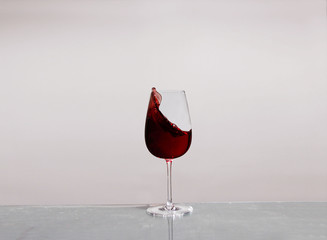 A glass of splashing red wine	
