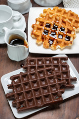 Tasty Belgian dessert, Brussels waffles with chocolade, syrup and white sugar powder