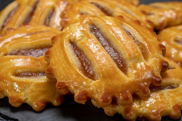 Small round fresh baked cookies filled with apples jam