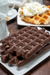 Tasty Belgian dessert, Brussels waffles with chocolade and whipped cream