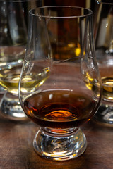Tasting of flight of Scotch whisky from special tulip-shaped glasses on distillery in Scotland, UK