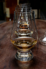Tasting of flight of Scotch whisky from special tulip-shaped glasses on distillery in Scotland, UK