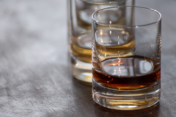 Tasting of flight of Scotch whisky from tumbler glasses in old Edinburgh pub,  Scotland, UK