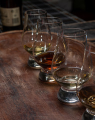 Obraz premium Tasting of flight of Scotch whisky from special tulip-shaped glasses on distillery in Scotland, UK