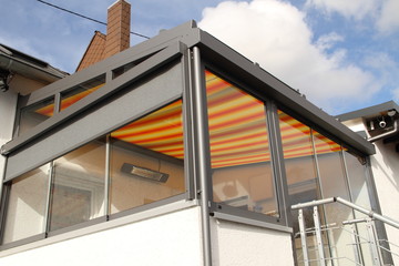 a modern new conservatory with awning