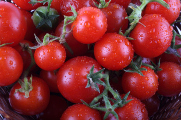 Red wet cherry tomatoes background