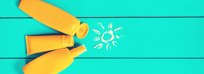 Sunscreen on a blue background. Selective focus.