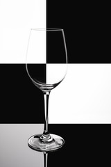 Wine glass on black and white domino background. phone wallpaper.