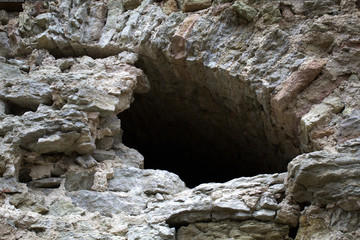 Window in an old medieval castle. Ruins, rough stone. Historical photography. The window arch is only half visible.