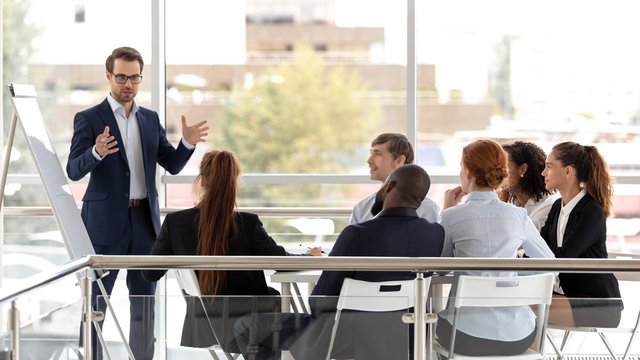 Successful coach businessman presenting new project to employee.