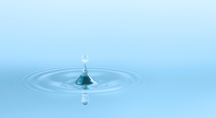 Naklejka na ściany i meble Water drop and circle ripple, light blue water, close up