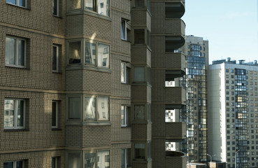  Apartment buildings.  Windows and balconies.  Urbanism.  Sunny day.