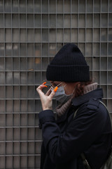 European tourist wearing a face mask in Barcelona protecting herself because the crisis of the coronavirus in China