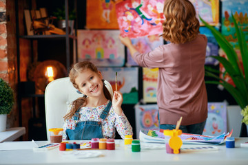 Fototapeta premium mother and child daughter painting draws in creativity in kindergarten.