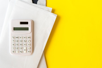 close up top of calculator with mail letters on yellow color background for utility expense of the month concept