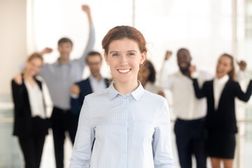 Close up portrait smiling millennial businesswoman in office.