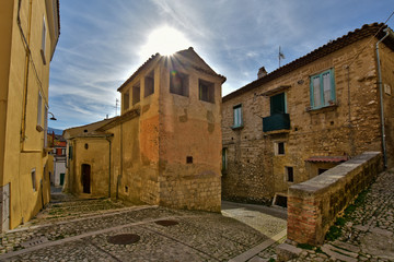 Fototapeta na wymiar Montesarchio, Italy, 02/29/2020. A narrow street between the old houses of a medieval village.