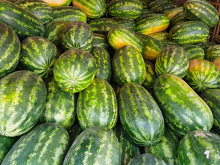 Fresh watermelons on a market in Yangon. Close-up watermelon background. Healthy food.