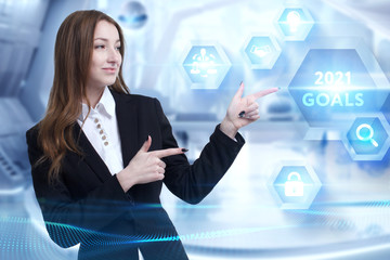Business, Technology, Internet and network concept. Young businessman working on a virtual screen of the future and sees the inscription: 2021 goals