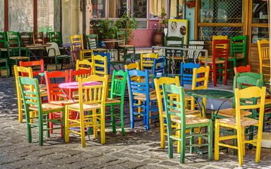A traditional cafe in the streets of Agiasos village in Lesvos with some colorful chairs