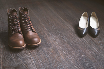 Men's and women's shoes made of leather on a wooden floor. Two pairs of vintage shoes.