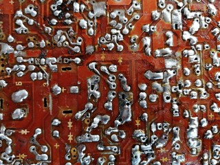 Industrial background and texture of a brown tin soldered motherboard