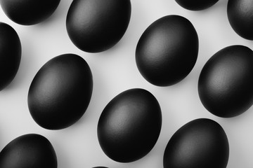 Pattern of black easter eggs on white background. Easter minimalistic concept