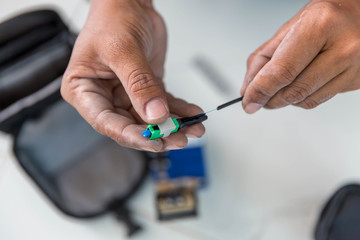 Optical fiber installation with Digital Fiber Optical Fusion Spl. High precision fiber optic cleaver is being used during a fiber optic wire installation at a house.  Welding of optical fibers. 