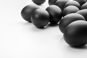 Composition of black easter eggs on a white background. Easter minimalistic concept
