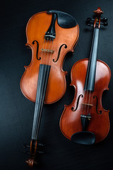 Violin and Viola put on background,show different size and detail of acoustic instrument,on black...