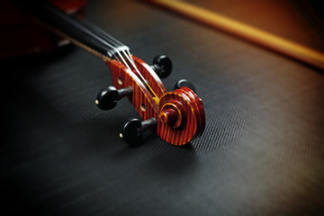 Blurred Scroll of violin put on background,vintage and art tone,blurry light around
