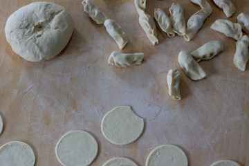 Dough rolled out in a pattern for preparation of ravioli or pelmeni. The rolled out dough. Rolled into a sausage dough. Flour dough for dumplings. Cooking dumplings