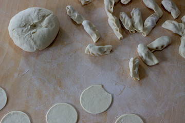 Dough rolled out in a pattern for preparation of ravioli or pelmeni. The rolled out dough. Rolled into a sausage dough. Flour dough for dumplings. Cooking dumplings