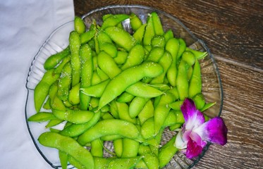 A bowl of steamed edamame green soya beans