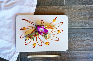 Ocean fried shrimp tempura roll sushi on a plate at a Japanese restaurant