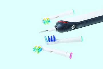 Three kinds of head and toothbrush close up view isolated on blue background.  Health care concept.