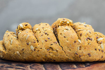 Homemade bread slices with flax, sunflower whole seeds on wooden board. Vegan and vegetarian healthy food.