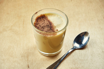 Close up view on tasty sweet tiramisu dessert in glass on wooden background. Italian cuisine dessert for coffee or tea.