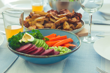 Closeup photo of served table with healthy vegetablesbowl and baked potato