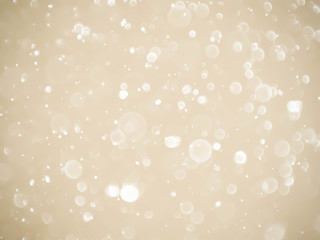 Golden background with soft bokeh lights.